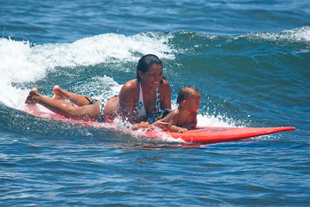 baby and mama surfing at Launiupoko
