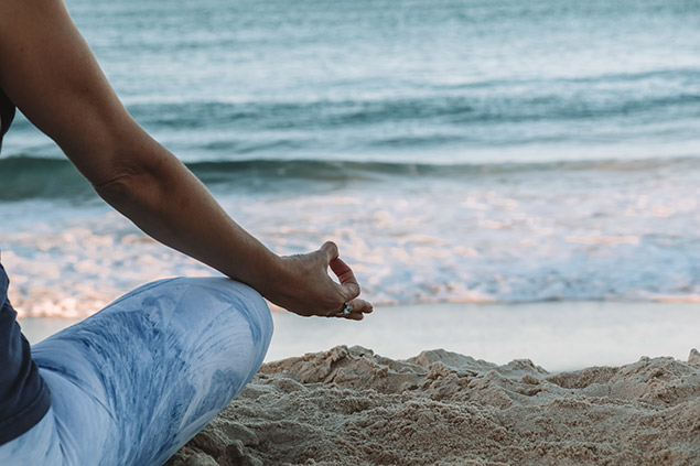 person meditating on a Hawaii beach